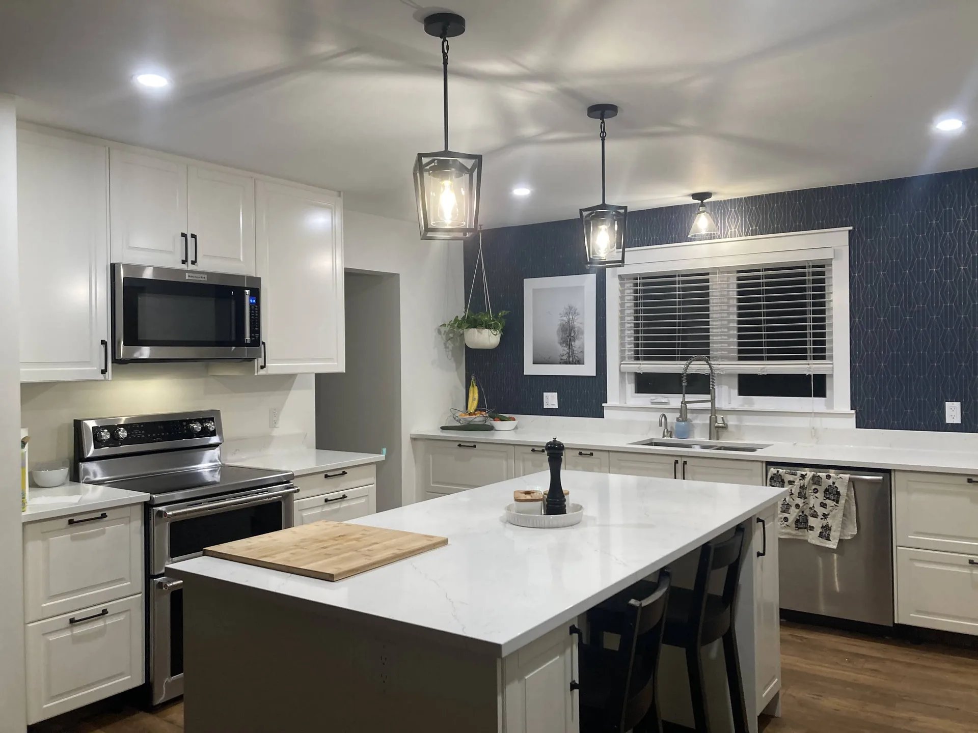 A completed Zacconi kitchen renovation with a white island and contrasting cabinetry